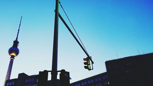 Low angle view of crane against blue sky