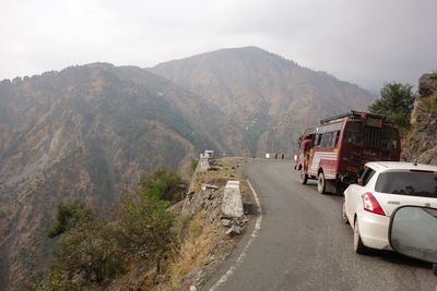 Road amidst mountains against sky