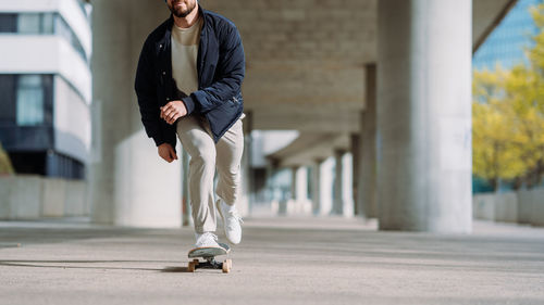 Low section of man skateboarding