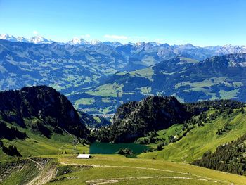 Scenic view of mountains against blue sky