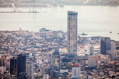 High angle view of buildings by sea against sky