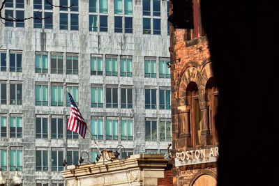 Low angle view of american flag on building in city