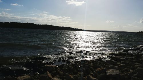 Scenic view of calm lake against blue sky