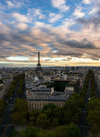 Buildings in city against cloudy sky