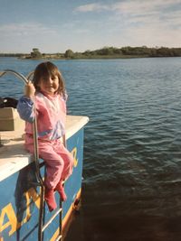 Full length of girl holding lake against sky