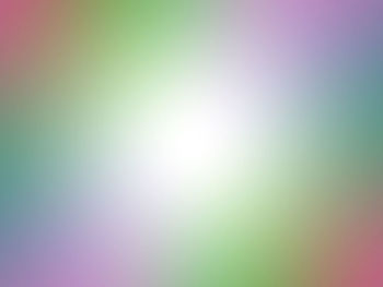 Defocused image of illuminated lights against sky