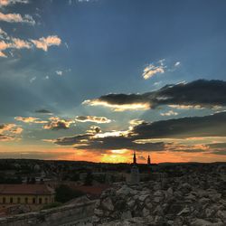 Silhouette buildings against sky during sunset