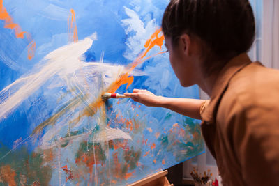 Close-up of woman painting at home