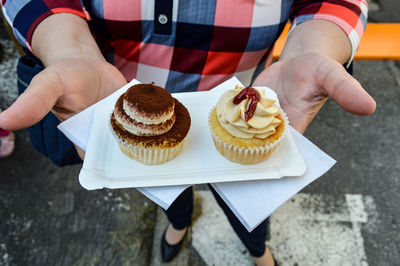 Close-up of pastries on hand