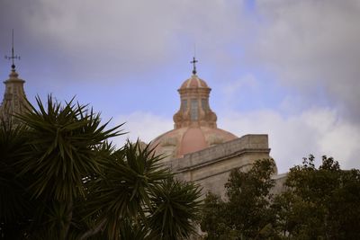 Low angle view of church against cloudy sky