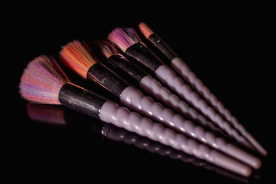 Close-up of colored pencils over black background
