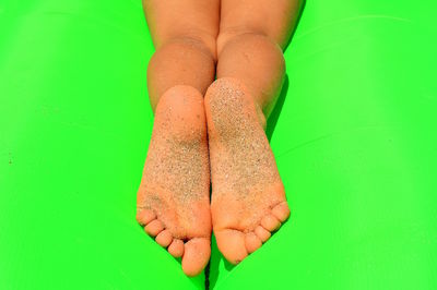 Low section of woman on wet leaf