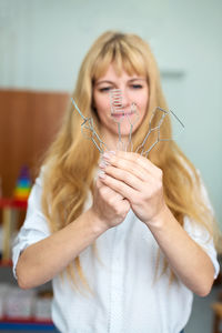 Midsection of young woman blowing bubbles