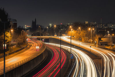 High angle view of light trails on road at night