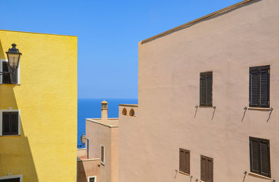 Low angle view of yellow building against sky