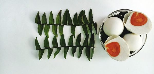 High angle view of vegetables on table against white background