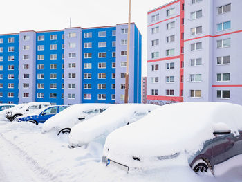 Street blocked by cover of fresh snow since night big snowstorm. cars covered with snow.