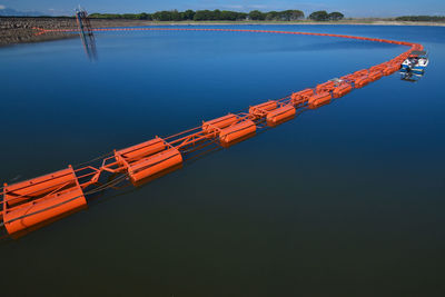 High angle view of crane by lake against sky