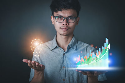 Digital composite image of man using smart phone against black background