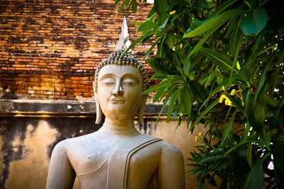 Statue of buddha against temple