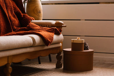 Midsection of woman sitting on sofa at home