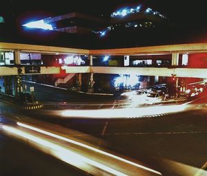 Illuminated cars in city at night