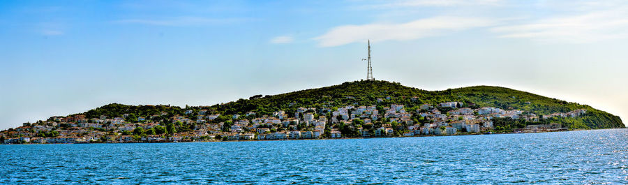 Scenic view of sea by building against sky