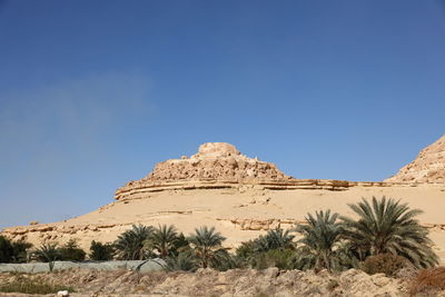 Rock formations in desert against clear blue sky