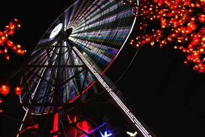 Low angle view of illuminated ferris wheel