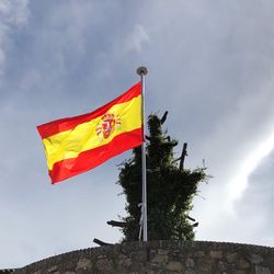 Low angle view of flag against sky