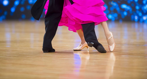 Low section of couple dancing on floor