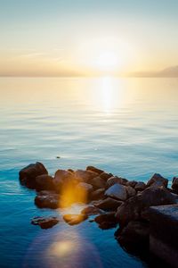 Scenic view of sea against sky at sunset