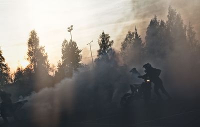 Motocross riders among smoke