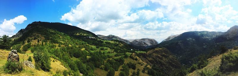 Scenic view of mountains against cloudy sky