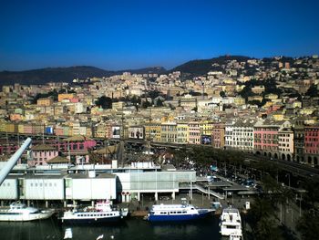 Boats in river with buildings in background