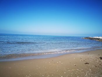 Scenic view of sea against clear blue sky