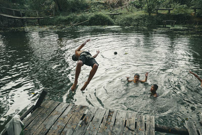 High angle view of men swimming in lake