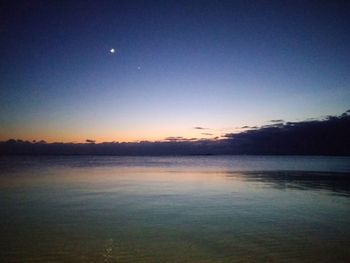 Scenic view of lake against sky at night