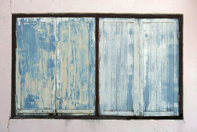 Close-up of blue window on old wall