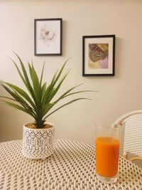 Kitchen table with a flower pot and drink on it