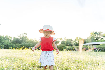 Toddler's first steps in the park. concept, learning and trying.