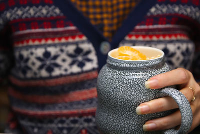 Cropped hand holding coffee