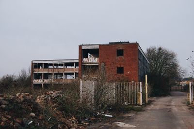 Abandoned building on field against clear sky