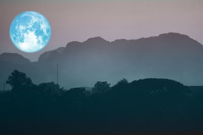 Scenic view of silhouette mountains against sky at night