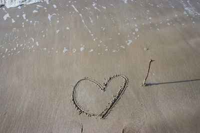 High angle view of heart shape on sand at beach