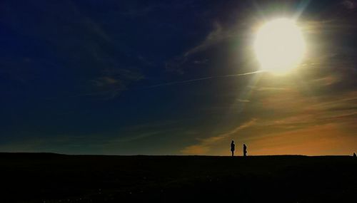 Silhouette people standing on landscape