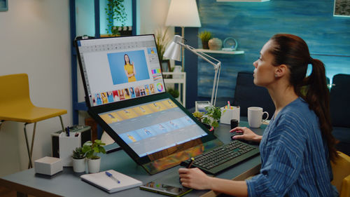 Young woman using laptop at office