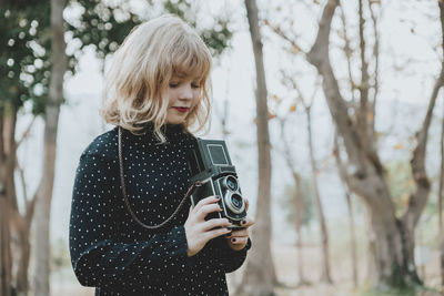 Young woman photographing camera