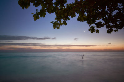 Scenic view of sea against sky at sunset