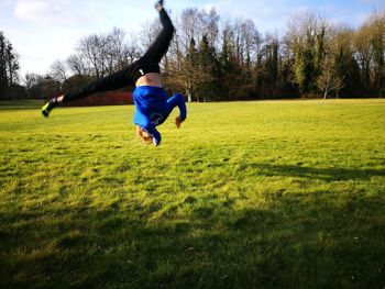 Full length of boy jumping on grass